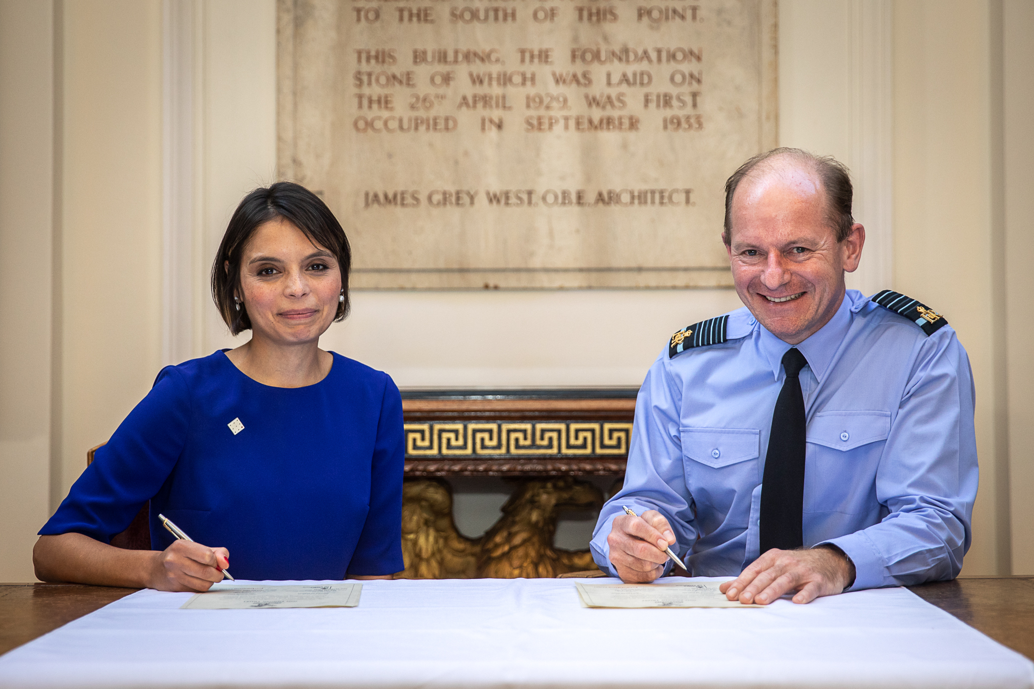 Image shows Chief of the Air Staff with Dr Emma Egging signing the document at a table.